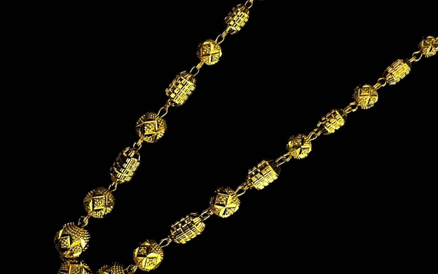 A 22ct gold chain of diamond-cut round and barrel beads