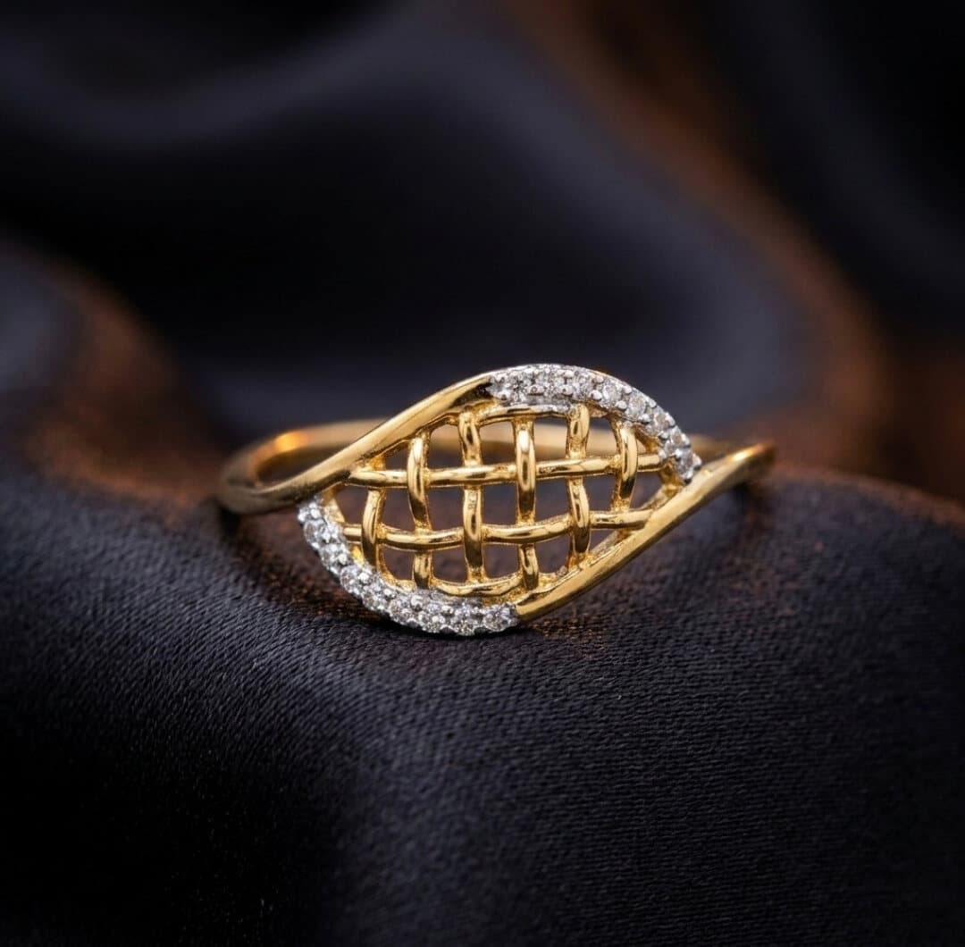 A gold ring with an open lattice centre edged with small white stones