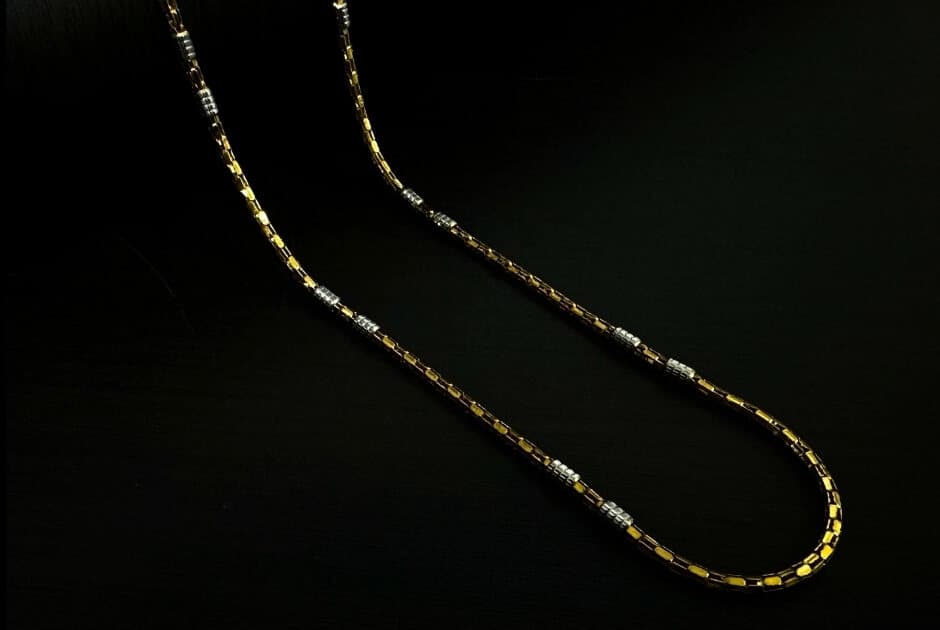 A 22ct two-tone gold chain with yellow box links and white-gold sections